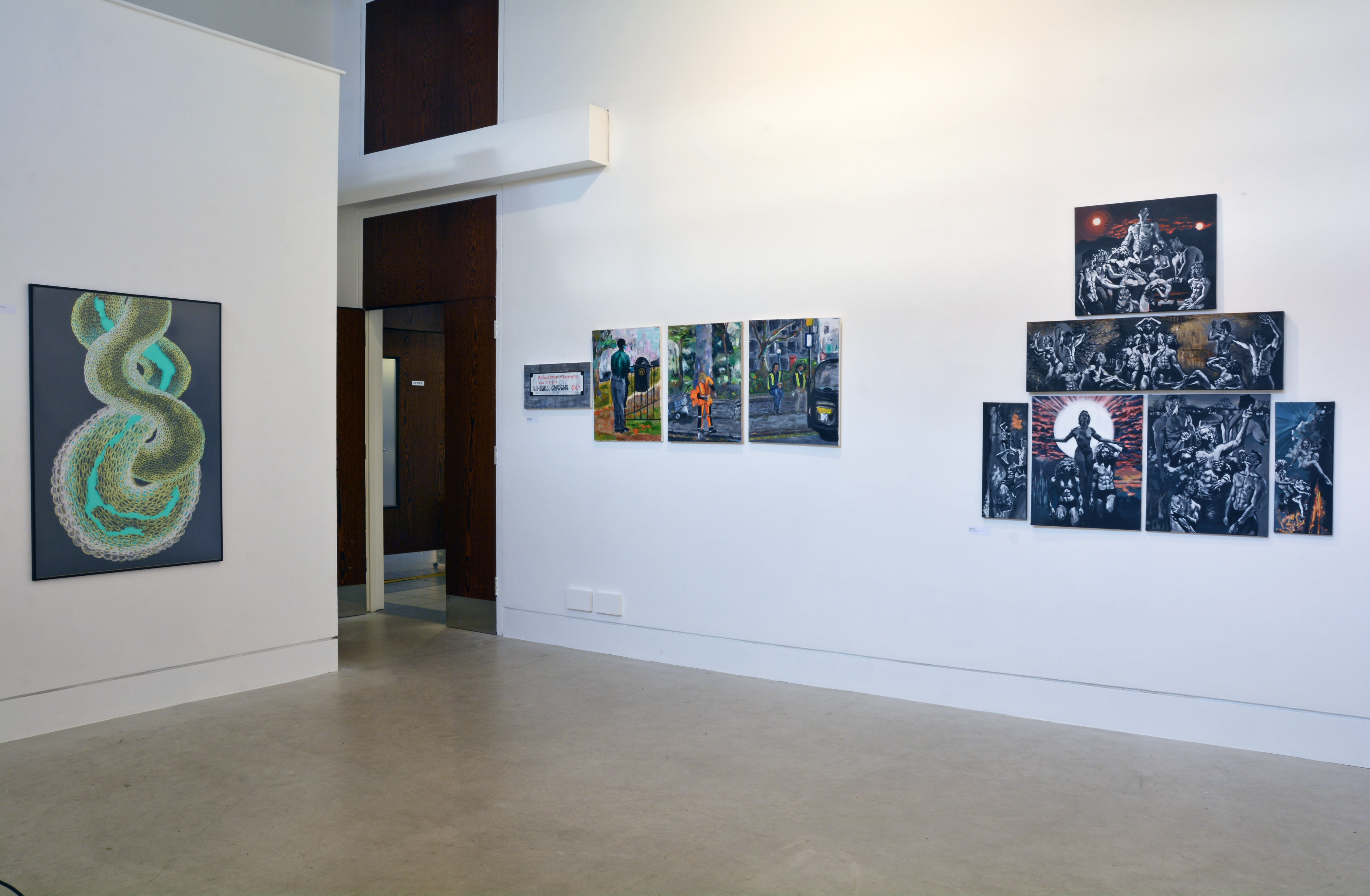 In a white walled space hangs a selection of artworks on the walls.